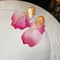 Macro shot of pink gradient acrylic flower earrings with golden metal findings - Pink