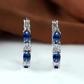 Silver hoop earrings with blue oval gemstones and clear cubic zirconia in claw setting - Sapphire Blue