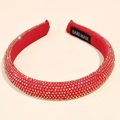 Detail of red rhinestone headband featuring a Hand Made label and shimmering crystals - 1.5cm wide / Red