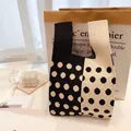 Knitted tote bag featuring black and white polka dot pattern with thick woven texture - Polka Dot