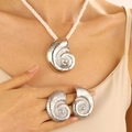 Silver conch jewelry set with chunky cord necklace and shell earrings on model - Silver Conch Jewelry Set