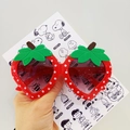 Red strawberry shaped children's sunglasses with white polka dots and purple lenses - Red
