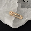 Detailed close-up of golden hollow oval metal hair clip with polished finish - Gold Long Oval Hollow Style