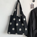 Close-up of white daisy embroidery on a black mesh canvas tote bag for a vintage aesthetic - Black Daisy Embroidery Canvas Bag