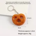 Realistic PVC pretzel food keychain with silver metal ring, dimensions 4.5cm x 5cm - Smiley Hash Brown Keychain