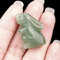 Miniature green crystal rabbit figurine carved from natural agate held in hand - Green Aventurine