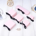 Elegant pink flip-top jewelry gift box with a black ribbon bow on white textured fabric - Light Pink (with Inner Support) / 5*5*3.5CM