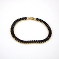 Detail of 18K gold plated bracelet featuring rectangular black crystals and fold-over clasp - Black