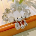 Ethnic beaded bracelet with silver fox and money bag charms on a white wooden display tray - 12mm Green Ghost: Nine-Tailed Fox Abundant Money Bracelet