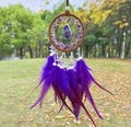 Detail of a purple dream catcher featuring a raw amethyst stone and soft feathers - Amethyst Brown Hoop