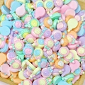 Macro shot of colorful resin lollipop charms with spiral textures and bow details - Swirl Lollipop
