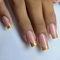 Macro detail of square press-on nails featuring pink base and gold gradient French tips - Minimalist Gold French