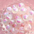 Close-up of clear luminous beads with white hearts and pink BOO text for DIY jewelry - BOO Letter / 16mm Luminous