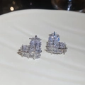 Macro shot of silver heart studs featuring step-cut cubic zirconia in a grid setting - Heart Lattice Style (HE30568) / Silver