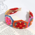 Macro detail of hand-knitted floral headband featuring colorful 3D crochet flowers - Wave Blue Orange Series