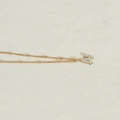 Elegant gold necklace featuring a letter N pendant encrusted with white pearls - Letter N