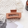 Detail of matte orange-pink rectangular hair claw clip on a white woven coaster - Medium Matte Square Claw-Orange