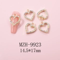 Detail of heart nail charms with colorful rhinestones on a pink nail, size 14.5x17mm - Gold Large Heart Pave AB Rhinestone Charm (9923)