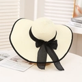 Elegant beige wide-brim straw sun hat with black ribbon bow for outdoor beach protection - White & Black