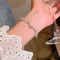 Elegant silver bracelet with iridescent crystal beads worn by a model holding glass - Silver/Magic Color Crystal