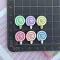 Macro detail of six colorful resin lollipops with heart accents and size measurement - Lollipop Mixed Colors
