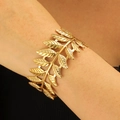 Detail view of golden laurel leaf cutout cuff bracelet on a female wrist - Laurel Leaf Style (H-195)