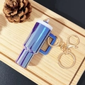 Miniature blue metallic cup keychain with white lid and golden metal clip on wood - Dazzling Deep Purple / Gold Buckle