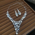 Close-up of pearl flower jewelry set with sparkling rhinestones in brown velvet box - Set 2 - Silver