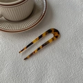 U-shaped hair pin with tortoiseshell pattern next to a coffee cup on a textured background - Dark Tortoiseshell