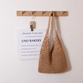 Minimalist hollow cotton woven shoulder bag in camel hung on a wooden wall hook - Checkered With Inner Bag / Brown
