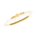Detailed macro view of beaded bracelet featuring gold-plated accents and lobster clasp - White Shell Flat Bead