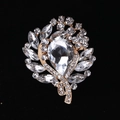 Elegant gold-tone crystal brooch featuring a large pear-shaped centerpiece and marquise stones - MM-BR-0027 / Gold