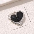 Macro shot of asymmetric black heart pendant with dimensions 2.1cm and 2cm - Asymmetric Black Gem Heart Style