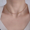 Close-up of beaded necklace with amber crystal facets and gold accents on a model - Caramel color