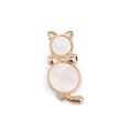 Close-up of golden cat brooch with white mother of pearl inlay and delicate bow detail - Gold Cat