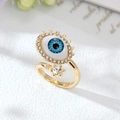 Anello malocchio dorato con centro blu e pietre in zircone bianco scintillante - Aperto/Con Strass / Azzurro