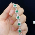 Close-up of emerald green princess cut bracelet with silver setting on hand - Green Zirconia (Silver)