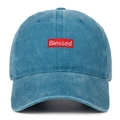 Close-up of Blessed embroidery and washed denim texture on blue cotton baseball cap - Lake Blue