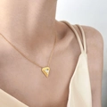 Minimalist gold chain necklace featuring a geometric triangle zircon pendant on a model - Triangle Zirconia