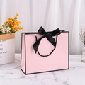 Elegant pink gift bag with black silk bow and handles made of premium white cardboard - 30*25*10cm / Pink with Black Edge + Black Ribbon