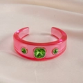 Detail of pink resin bangle featuring green gemstones and sparkling rhinestone accents - Rose Red - Green