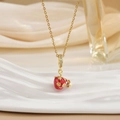 Macro shot of gold necklace with red strawberry pendant and sparkling crystal inlay - Rhinestone Inlaid Style (XL0547)