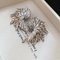 Macro detail of silver curved fan earrings with a high-gloss metallic finish - Silver (925 Sterling Silver Earring Post)