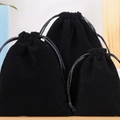 Three sizes of black velvet drawstring jewelry bags displayed on a wooden base - 10*12cm Black Velvet Pouch-9*9*1.6cm