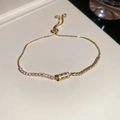Detail of gold adjustable bracelet with sparkling zircon cylinder charm and slider clasp - Gold Round