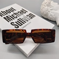 Detail view of tortoiseshell rectangular sunglasses with dark brown lenses and size specs - Leopard Print