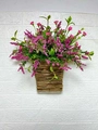 Close-up of artificial pink berries and wildflowers in a rustic woven hanging basket - Model A (Boxed)