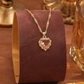 Detail of peach heart crystal pendant with pavé cubic zirconia on gold Singapore chain - Orange