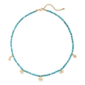 Detail of blue beaded necklace with gold butterfly and star charms and white rhinestones - Lake Blue Beads-Butterfly & Star Pendants