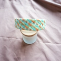 Detail of colorful woven raffia headband with orange and blue textured patterns - Green Series Colorful Plaid
